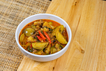 Top view of Thai beef red curry, Thailand tradition red soup with beef and coconut milk, Panaeng Curry in white plate, Thai curry, Thai food, Beef Recipe.