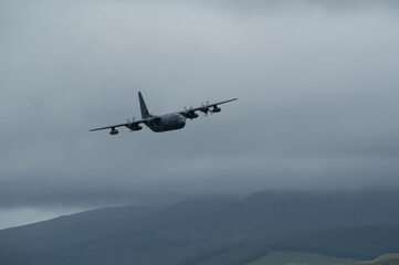 C-130 Hercules transport aircraft low level flying training in mach loop valley Wales