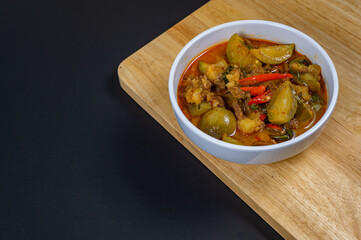 Top view of Thai beef red curry, Thailand tradition red soup with beef and coconut milk, Panaeng Curry in white plate, Thai curry, Thai food, Beef Recipe.