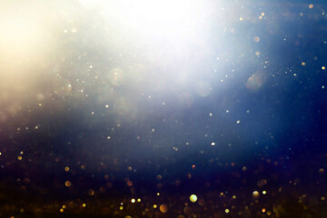 background of abstract black, gold and blue glitter lights. defocused
