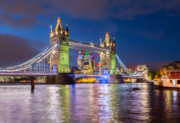 The famous iconic and historical Tower Bridge at night illuminated in London