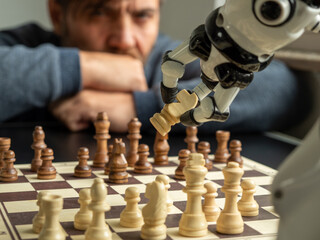 A man plays chess with a robot.