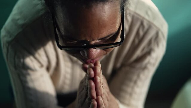 Faithful South American hispanic older woman praying to God at home. Spiritual hispanic Brazilian senior female person in prayer having HOPE and FAITH