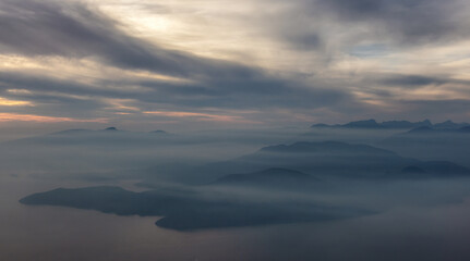 Canadian Mountain Landscape on the West Coast of Pacific Ocean. Dramatic Sunset and Hazy Smoky Sky. St. Mark's Summit near Vancouver, British Columbia, Canada. Nature Background