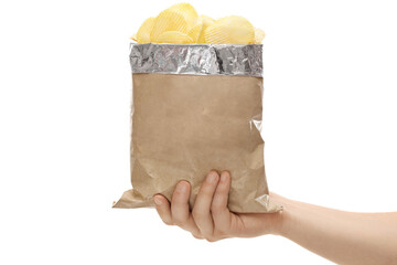 Hand holding a brown bag full of potato crisps