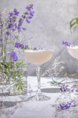 Two Elegant glasses of Lavender Cocktail or mocktails surrounded by ingredients and fresh lavender...