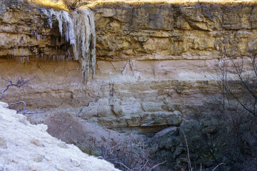 Frozen waterfall in the wild. Landscape background with copy space