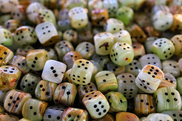 Dice made of natural stone. Background with selective focus and copy space