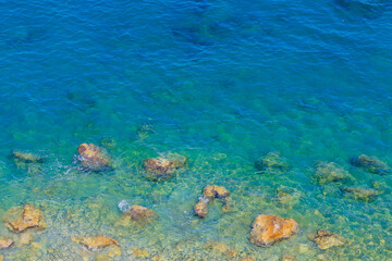 Very beautiful background or backdrop of sea water with rocky shore, selective focus