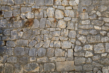 Ancient stone wall in the architecture of the old town. Background or backdrop