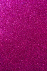 Background with sparkles. Backdrop with glitter. Shiny textured surface. Vertical image. Dark pink