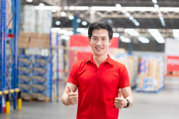 Cheerful man smiling with giving thumbs up, Warehouse worker working in factory warehouse