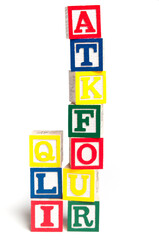 colorful wooden cubes with alphabet letters, isolated