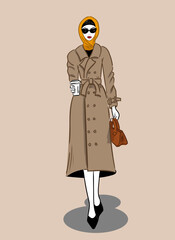 A stylish woman in a raincoat, scarf and sunglasses goes with a cup of coffee.