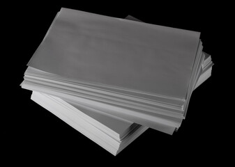 Stack white paper for writing and printing isolated on black 