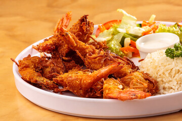 Fried shrimp breaded with coconut, sweet sauce, salad and rice, food, gastronomy