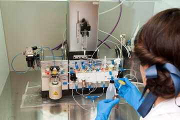 Technician preparing chemical radioactive contrast agent medicine for radiology and nuclear...