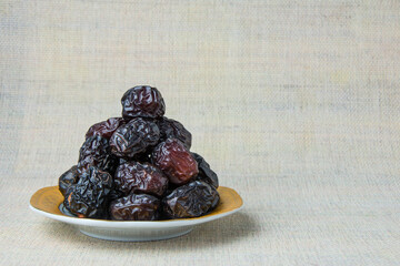 Delicious ajwa dates ( kurma nabi ), Much sought after during the month of Ramadan as a dish for breaking the fast, ramadhan kareem, empty space, copy space.