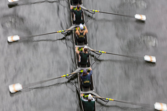 Overhead view of female crew racers rowing in an octuple racing shell, an eights team.