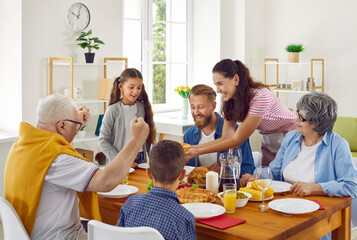 Family meal. Joyful family enjoying dinner at home. Happy family with little children sitting...