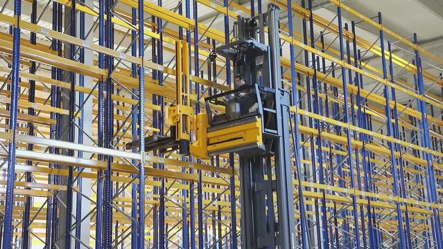 High Rack Stacker Forklift at Empty Shelving System in New Warehouse zoom in