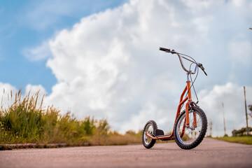 modern light skick scooter. Road in nature. The concept of eco-friendly movement.