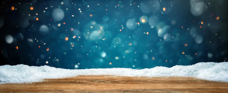 Wooden table with snow texture background for Christmas and winter holidays