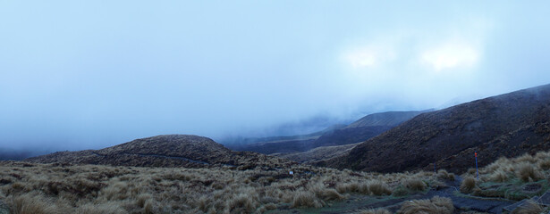 Fototapeta na wymiar Hiking in bad weather on the Tongariro Alpine Crossing in New Zealand.