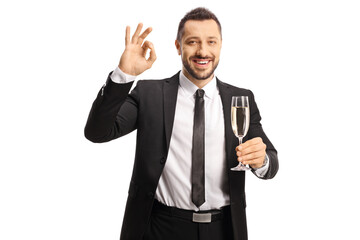 Businessman holding a glass of champagne and gesturing good sign