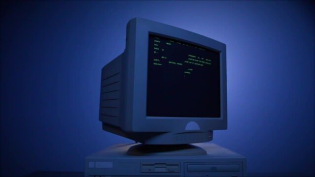 Retro pc with loading code console, programmer making scripts, green basic screen, Old computer studio blue night background close-up, Desktop vintage retro wave display, late 90s PC.