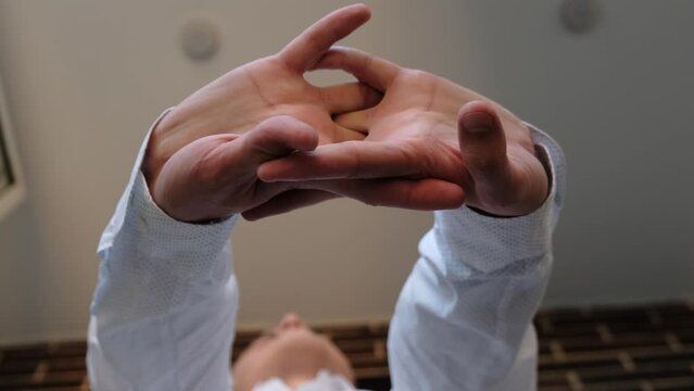 Man stretching his hands during the working day. A man cracks his knuckles