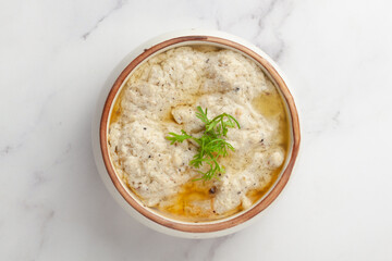 Close-up of Malai Paneer or Kali Mirch or Kalimirch, prepared in a white creamy(malai) gravy and black pepper powder sprinkled over it garnished with fresh green coriander leaves. 