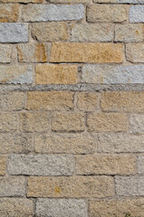 stone wall of regular granite blocks for backgrounds