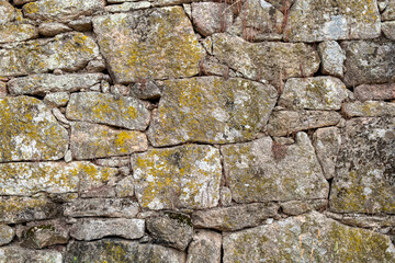 detail of a granite stone wall of an old house in Portugal