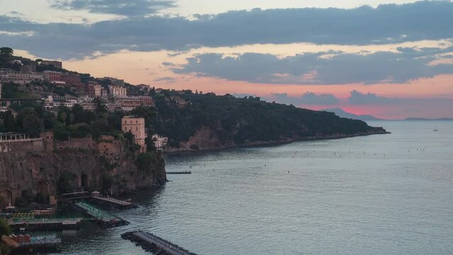 Sorrento, Italy. Time lapse video from sunset to night with lights that turn on, on the bay of Sorrento. In the distance the island of Capri. August 23, 2022.