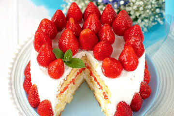 Taking of delicious strawberry cake from plate by using shovel, closeup. selective focus. festive berry cake. homemade strawberry cake cut. 