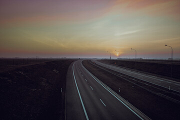 Fototapeta premium Road to sunset - highways, two lanes with a turn