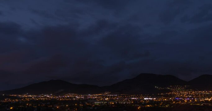 Darkness in Bodrum, city lights, clouds and mountains.