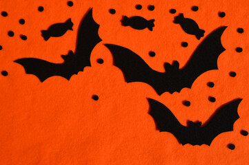 Fototapeta premium preparation for the Halloween holiday. bat made of felt. orange background for the design.