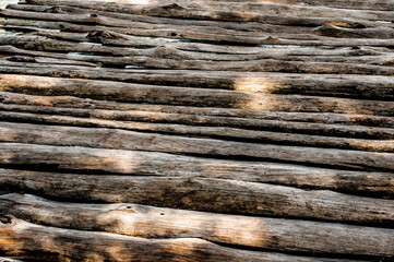 Wooden flooring with sun rays on the forest lake.