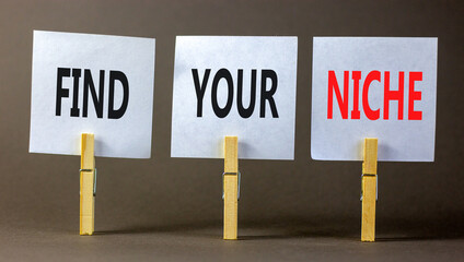 Find your niche symbol. Concept words Find your niche on white papers on wooden clothespins....