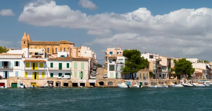 Panoramic view of PORTO COLOM in the island of MAJORCA (MALLORCA in Spanish),quiet village,with the movement of the clouds and small pleasure boats on a sunny day.Time Lapse.Camera movement: Panning.