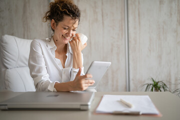 One woman working in the office and talk online using digital tablet