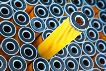 New yellow machine filters, stacked to each other and one filter on top of them.