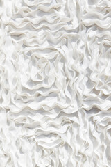 Close up of white ruffled fabric.
