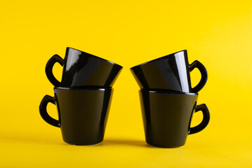 The cups are black on a bright yellow background for guests.