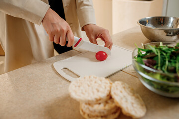 Close up of woman preparing vegetable vegan salad in the kitchen. Healthy food and diet concept lifestyle. Cook at home