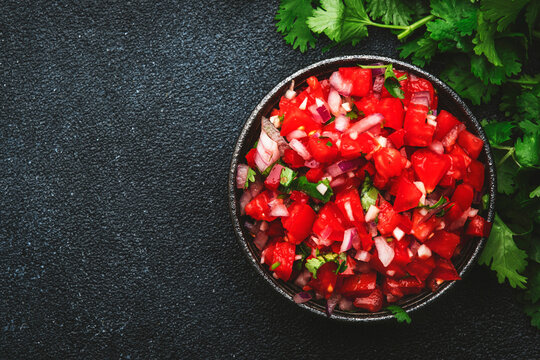 Mexican Food. Spicy Salsa Sauce With Tomatoes, Chili Peppers, Onion, Garlic And Cilantro, Black Table Background, Top View