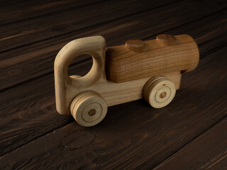 Wooden toy car on a dark background