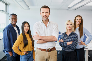 Leadership concept. Group photo of diverse business people standing at office with ceo, manager or...